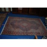 A contemporary bordered, patterned and fringed Eastern Rug, finely decorated against a cream,