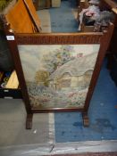An Oak framed Firescreen having a fluted top rail and with an inset tapestry depicting a thatched
