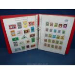 A red stamp album with world stamps.
