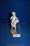 A 19th century Sitzendorf figurine of two children playing a climbing game. 6 1/4" tall.