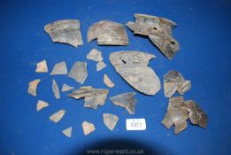 An interesting box of ancient pottery shards mainly with raised or moulded decoration,