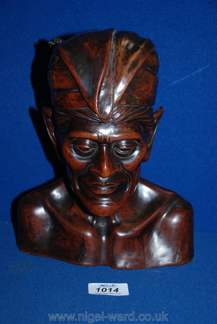 A carved Indonesian wood head, 9 1/2'' tall.