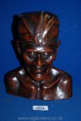 A carved Indonesian wood head, 9 1/2'' tall.