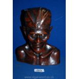 A carved Indonesian wood head, 9 1/2'' tall.