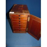 A Victorian Mahogany single door collector's Cabinet, enclosing seven drawers.