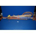 A quantity of vintage sporting goods to include; cricket bat and leather ball, hockey stick,