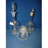 Two decanters with stoppers and a small storage jar with lid.