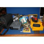 A Kodak Carousel S-AV 1000 projector, slide trays, a projector lens and Super 8 film reels.