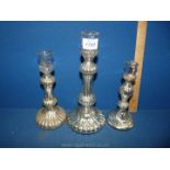 Three hollow glass candlesticks with silvered interiors. 10", 8" and 7 1/4" tall. Some chips.