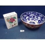 An oriental fruit Bowl with blue pattern interior and russet floral decorated exterior,