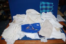 Two trays of assorted crochet table place settings, blue Portuguese bag, etc.