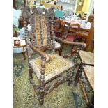 An early peg joyned mainly Oak framed open armed Elbow Chair profusely carved with foliage,