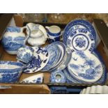 A quantity of blue and white china including jugs, willow pattern plates,