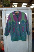 A 'Geiger' multi coloured Pure new wool three quarter length Jacket, purple/green with metal brooch,