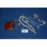 A quantity of rosary beads, mother of pearl beads, leather rosary pouch, pewter brooch, etc.