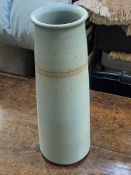 A stylish tapering cylinder shaped blue tall Stoneware Vase with speckled finish and a glaze-resist