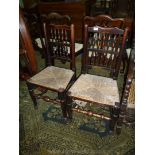 A pair of Oak framed Dining Chairs of Clissett style construction but with spindle turned details