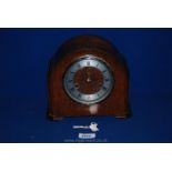 A 1930's Oak Smiths mantle Clock with Roman numerals, 7 1/2'' tall, with key.