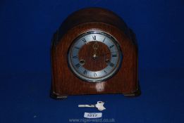 A 1930's Oak Smiths mantle Clock with Roman numerals, 7 1/2'' tall, with key.