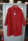 A 'Kirsten' burgundy long zip up Coat, size 12.