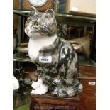 A large Winstanley grey Tabby cat sitting, 12 1/2'' tall with glass eyes and signed to the base.