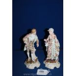 A late 19th century pair of porcelain figures of a lady and gentleman in 18th century dress,