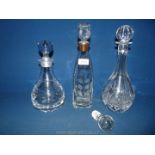A square Decanter with silver rim and etched leaves pattern plus two other decanters one Thomas