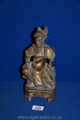 An antique Chinese carved wooden gilt-lacquered deity figure,