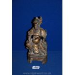 An antique Chinese carved wooden gilt-lacquered deity figure,