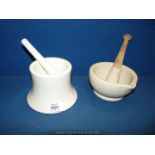 A china pestle and mortar together with another pestle and mortar.