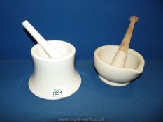 A china pestle and mortar together with another pestle and mortar.