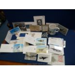 A basket containing war memorabilia including Wings of Defence mug, postcards, aeroplane cards, etc.