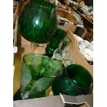 A quantity of green glass including brandy balloon vases, a mottled jug,