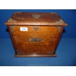 An Edwardian Oak correspondence Box with metal mounts and cantilevered fitted interior with shield
