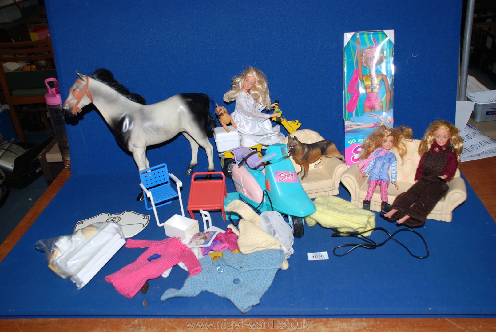 A box of Sindy accessories to include; a horse, scooter, settee, etc.