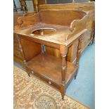 A Victorian Mahogany Washstand standing on turned legs,