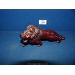 A small carved wood Lion, 7'' long by 3 1/2'' tall,