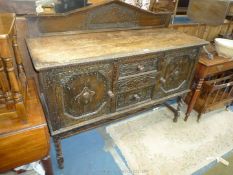 A Jacobean flavour carved detailed dark Oak 1940/50's Sideboard standing on mirrored twist legs