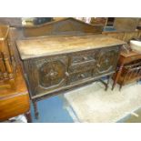 A Jacobean flavour carved detailed dark Oak 1940/50's Sideboard standing on mirrored twist legs