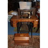 A Singer Treadle sewing Machine, with drawers complete with contents including machine accessories,