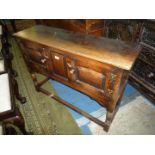An Old Charm/Priory Oak style compact Sideboard having central rectangular raised and fielded panel