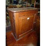 An antique Oak Spice/Medicine Cabinet, the door having a raised and fielded panel and brass knob,