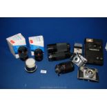 A Kodak EK 160-EF Instant Camera and three close focus telephoto/zoom lenses together with a