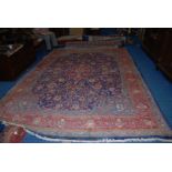 A large contemporary Iranian bordered, patterned and fringed Rug,