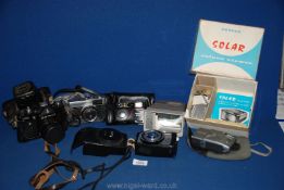 A quantity of SLR film cameras including a Zenit TTL, Olympus trip 35, Nikon RF10,