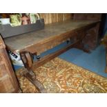 A dark Oak Refectory style dining table having fretworked slat supports unified by a central pegged