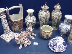 A quantity of oriental china including well bucket, candlestick, bowl, dogs, etc.