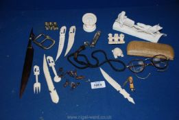 A cased pair of old glasses, miscellaneous bone letter openers, whistle, large buckle etc.