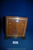 An Art Deco style mantle Clock of square form having quarter-veneered face with Roman numerals at