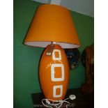 A large orange Louis Drimmer table Lamp and matching shade.